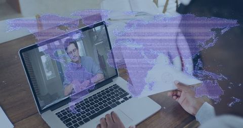 Remote business conference call with world map overlay on laptop