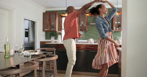 Joyful Couple Dancing in Cozy Kitchen Setting