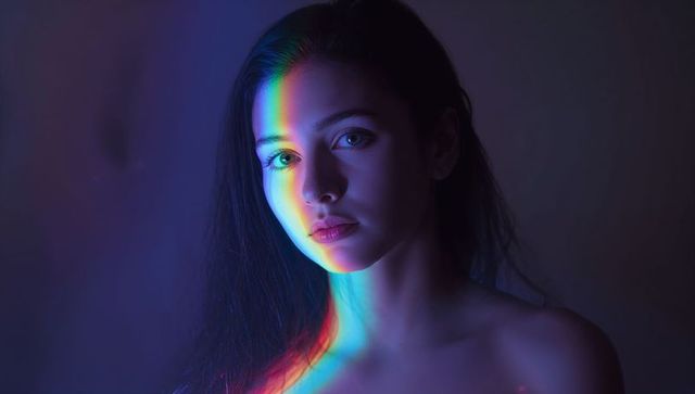 Rainbow Reflection on Woman's Face in Moody Lighting