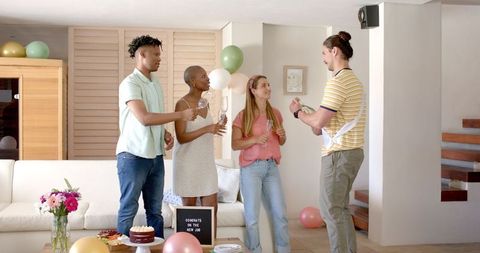 Friends Celebrating Together with Champagne at Home