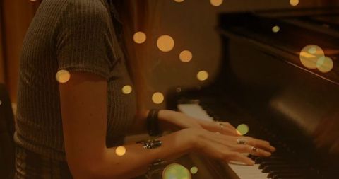 Skilled Pianist Performing in Ambient Setting with Bokeh Lights
