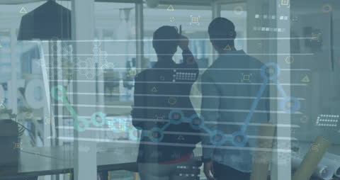 Silhouetted Professionals Analyzing Data Visualization in Modern Office