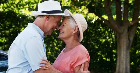 Senior Couple Embracing in Sunny Garden - Download Free Stock Images Pikwizard.com