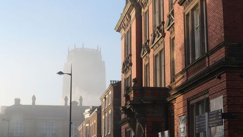 Historic Red Brick Buildings on Foggy Morning with Cathedral in Background - Download Free Stock Images Pikwizard.com