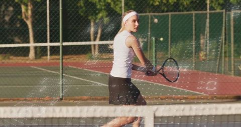 Female Tennis Player Preparing Backhand Shot During Match