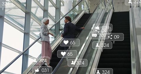 Business colleagues networking on escalator with digital social icons
