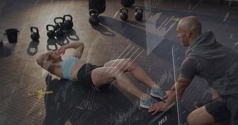 Woman Performing Sit-Ups in Gym with Trainer's Support