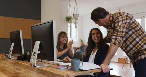 Creative Team Enjoying Informal Interaction in Modern Office