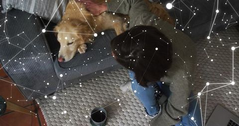 Woman Relaxing at Home While Petting Golden Retriever