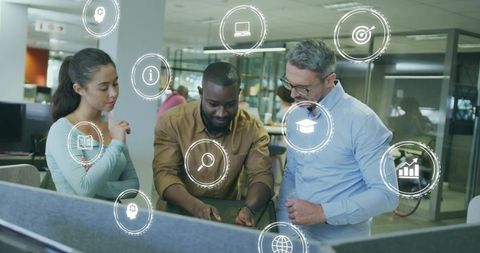 Colleagues discussing project with data icons present in office