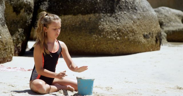 Girl Playing in Sand with Bucket on Beach - Download Free Stock Images Pikwizard.com