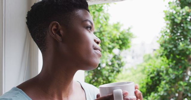 Reflective Woman Holding Mug By Window, Looking Outside Thoughtfully - Download Free Stock Images Pikwizard.com