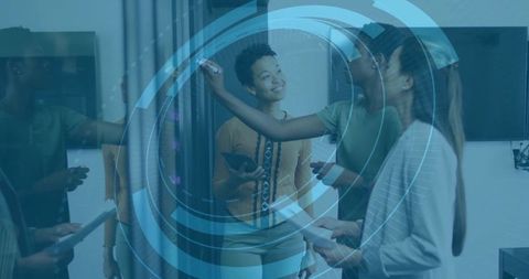 Business professionals brainstorming at whiteboard with technology overlay