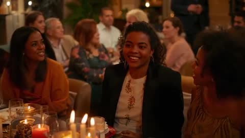 Group Sharing Warm Candlelit Dinner Conversation, Laughing and Connecting at Evening Gathering