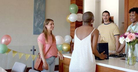 Friends Gather at Home Celebrating with Balloons and Smiles