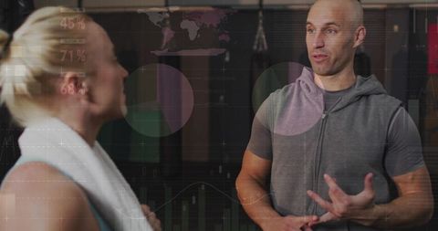 Fitness Coach Reviewing Performance Data with Client in Gym