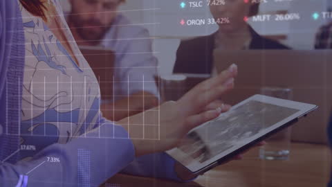 Woman Analyzing Financial Data on Tablet in Office Environment