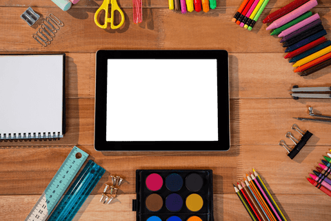 transparent tablet surrounded by colorful stationery essentials - Download Free Stock Videos Pikwizard.com