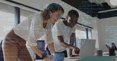 Women colleagues reviewing code in modern office environment