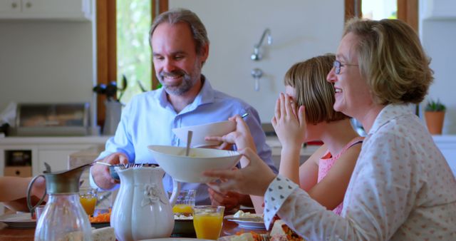 Happy Family Having Breakfast in Kitchen - Download Free Stock Images Pikwizard.com