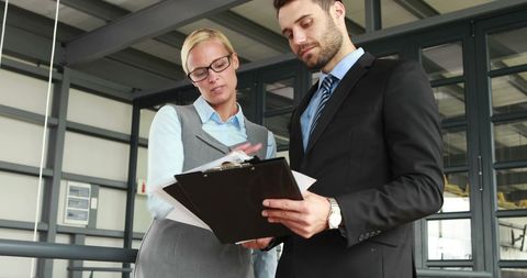 Focused Business Discussion Between Colleagues in Corporate Office