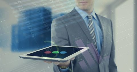 Businessman Using Tablet with Financial Data Interface - Download Free Stock Images Pikwizard.com