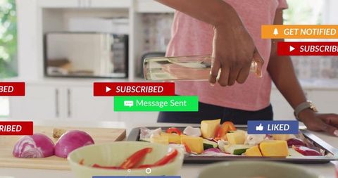 Home cooking vlogger drizzling olive oil on roasting vegetable tray with social alerts