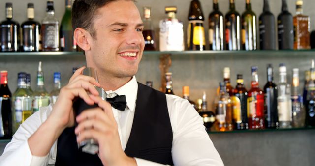 Smiling Bartender Shaking Cocktail Shaker Behind Bar Counter - Download Free Stock Images Pikwizard.com