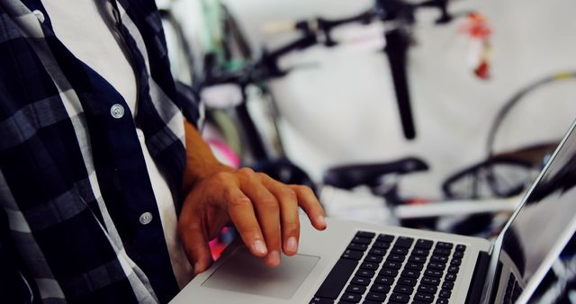 Developer Working on Laptop Near Bikes - Download Free Stock Images Pikwizard.com