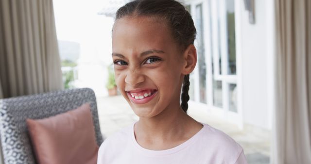 Playful Young Girl Smiling with Braided Hair - Download Free Stock Images Pikwizard.com