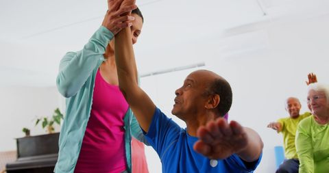 Senior Man Performing Yoga with Female Trainer Assistance in Studio - Download Free Stock Images Pikwizard.com