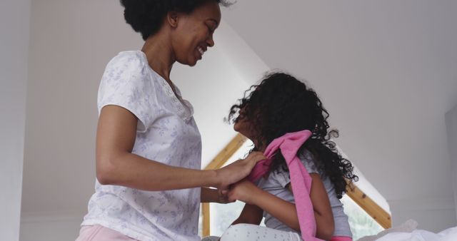 Mother Dressing Her Daughter with Pink Scarf at Home - Download Free Stock Images Pikwizard.com