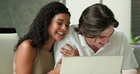 Joyful Multiracial Couple Using Laptop Together