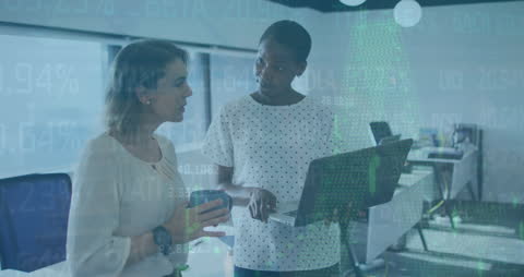 Diverse Female Colleagues Discussing Financial Strategies in Office