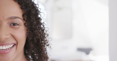 Half Face of Smiling Woman with Curly Hair in Soft Light - Download Free Stock Images Pikwizard.com