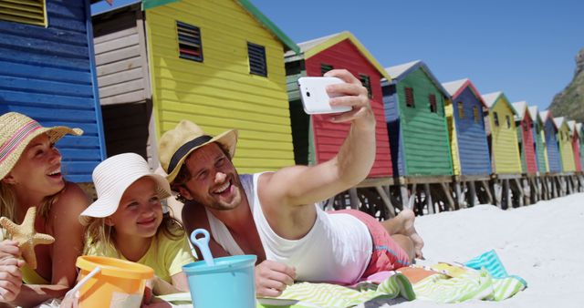 Family Taking Selfie on Beach Near Colorful Beach Huts - Download Free Stock Images Pikwizard.com