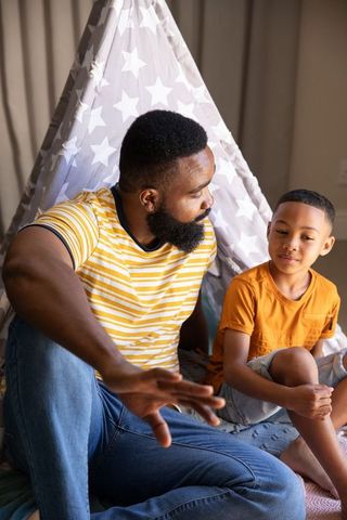 African American Father and Son Bonding in Playful Teepee Tent