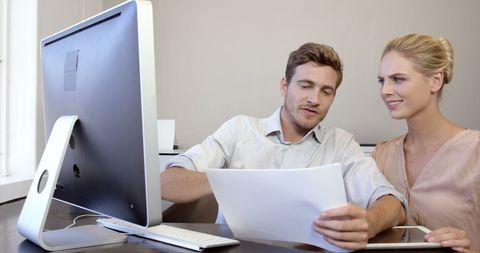 Colleagues Analyzing Documents and Working on Computer - Download Free Stock Images Pikwizard.com