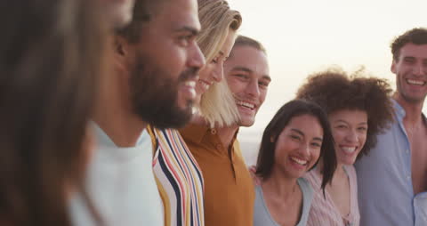 Group of Friends Embracing on Tropical Beach at Sundown