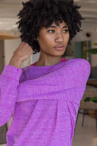 Active Black Woman Stretching in Casual Purple Top Indoors