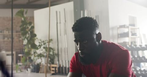 Athlete sweating and gasping for breath in gym environment