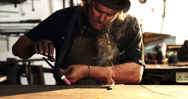 Focused Blacksmith Working on Metal Art in Workshop - Download Free Stock Images Pikwizard.com