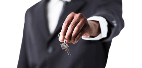 Confident Businessman Presenting House Key Close-Up Transparent Background