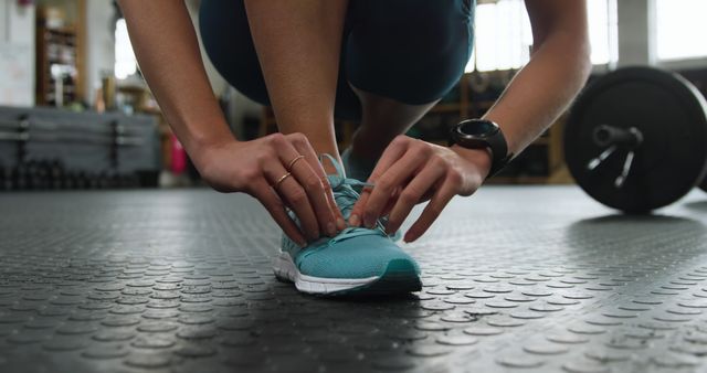 Close-Up of Person Tying Shoe in Gym - Download Free Stock Images Pikwizard.com