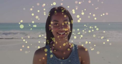 Joyful Woman at Beach with Golden Bokeh Effects