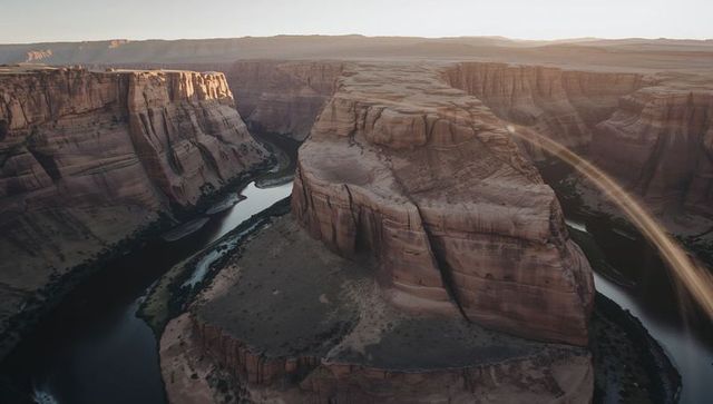 Revealing horseshoe mesa overlooking winding river and canyon walls at golden hour