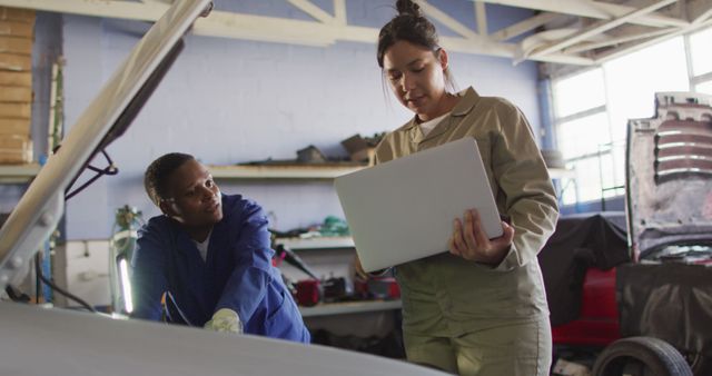 Technicians Using Laptop for Car Repair in Garage Workshop - Download Free Stock Images Pikwizard.com