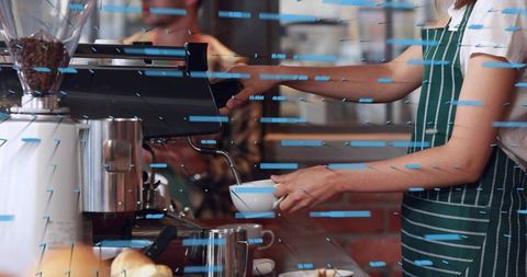 Barista pulling espresso in green-striped apron at cafe counter with blue light streaks