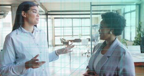 Professional Businesswomen Strategizing in Modern Office