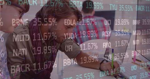 Business meeting amidst financial data visualizations